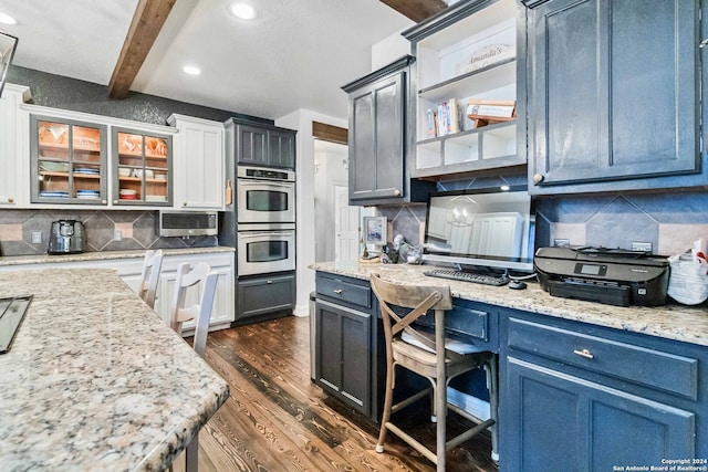 kitchen with blue cabinets, decorative backsplash, dark hardwood / wood-style flooring, and beamed ceiling