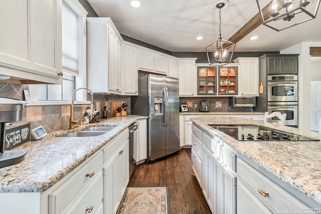 kitchen with stainless steel appliances, dark hardwood / wood-style floors, tasteful backsplash, and white cabinetry