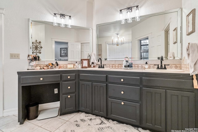 bathroom with vanity, a chandelier, and tile patterned flooring