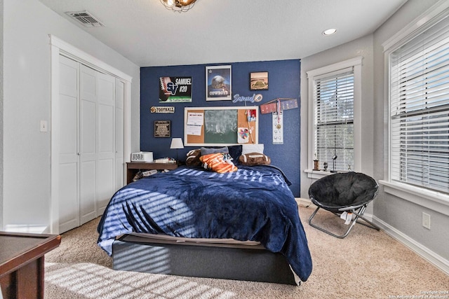 carpeted bedroom featuring a closet