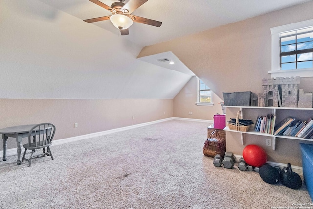 interior space with carpet flooring, vaulted ceiling, and ceiling fan