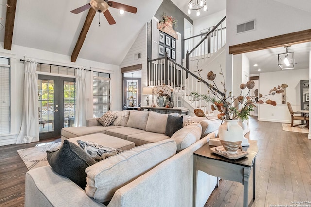 living room with high vaulted ceiling, ceiling fan with notable chandelier, french doors, hardwood / wood-style flooring, and beam ceiling