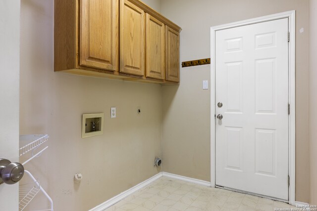 laundry area featuring hookup for an electric dryer, hookup for a gas dryer, cabinets, and hookup for a washing machine