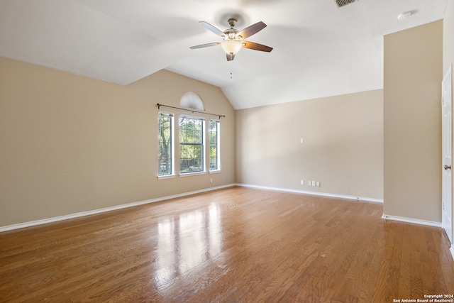 unfurnished room featuring wood-type flooring, ceiling fan, and lofted ceiling