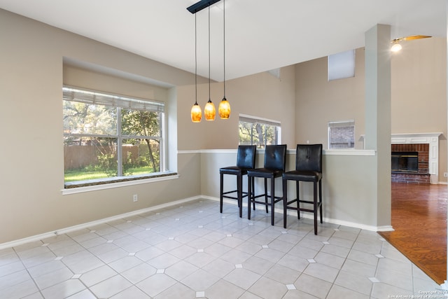 dining room featuring light hardwood / wood-style flooring and a brick fireplace