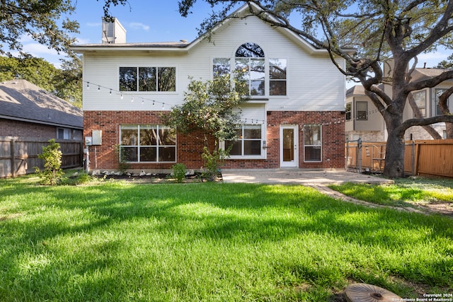 rear view of property with a yard