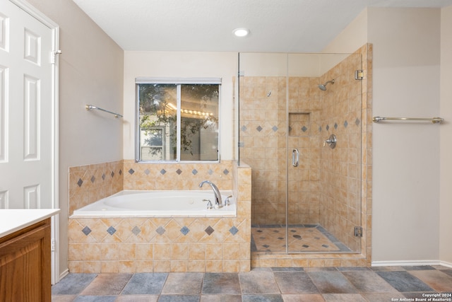 bathroom featuring vanity and plus walk in shower