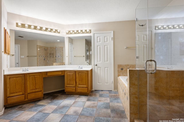 bathroom featuring vanity and separate shower and tub