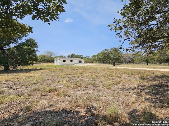 view of yard with an outbuilding and a rural view