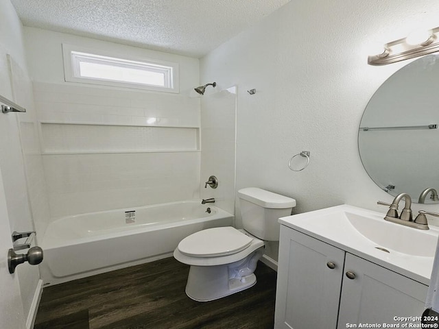 full bathroom with toilet, wood finished floors, a textured ceiling, vanity, and shower / bathing tub combination