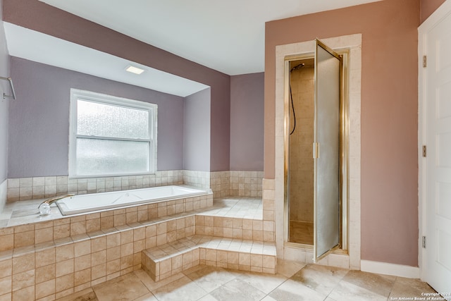 bathroom with separate shower and tub and tile patterned flooring