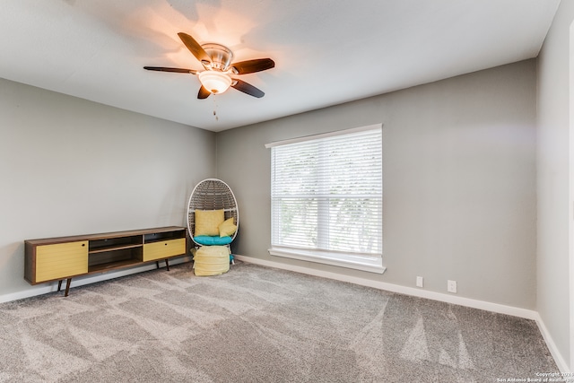 interior space with carpet flooring and ceiling fan