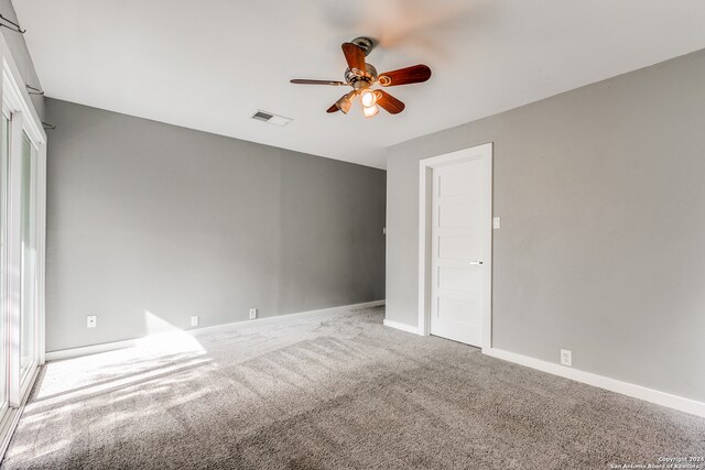 empty room with carpet flooring and ceiling fan