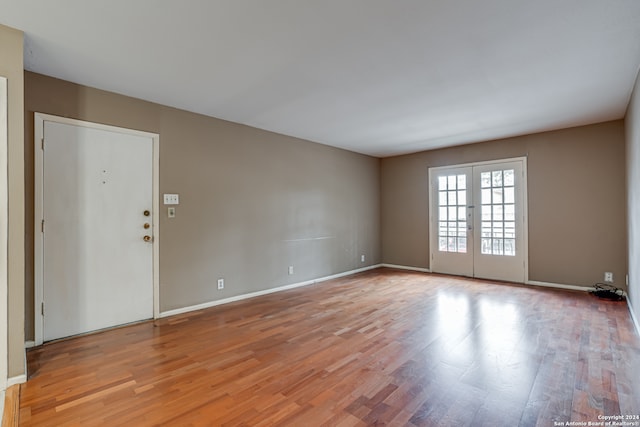 unfurnished room featuring light hardwood / wood-style flooring and french doors