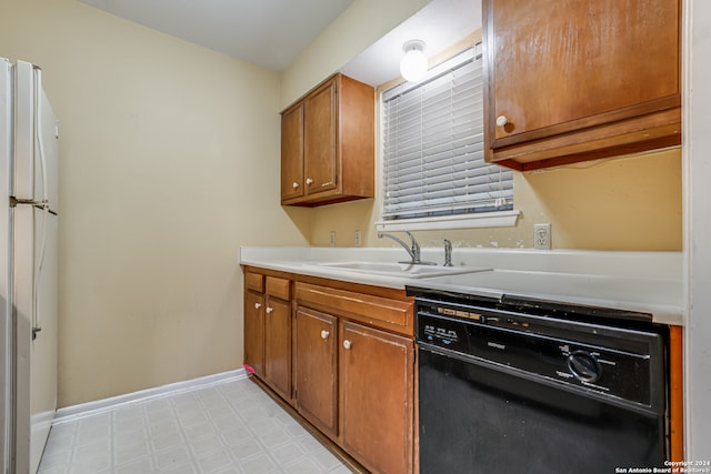 kitchen with dishwasher, sink, and white fridge