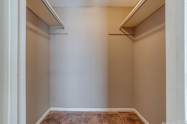 spacious closet with tile patterned floors