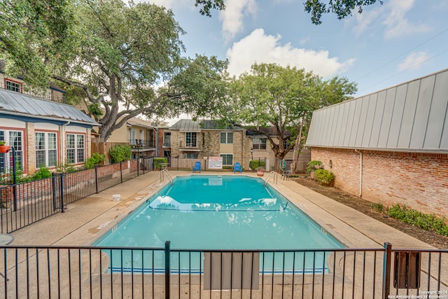 view of swimming pool with a patio