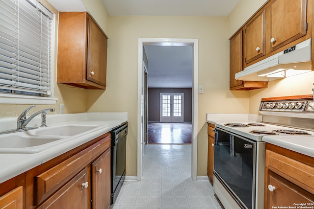 kitchen featuring dishwasher, sink, and electric stove