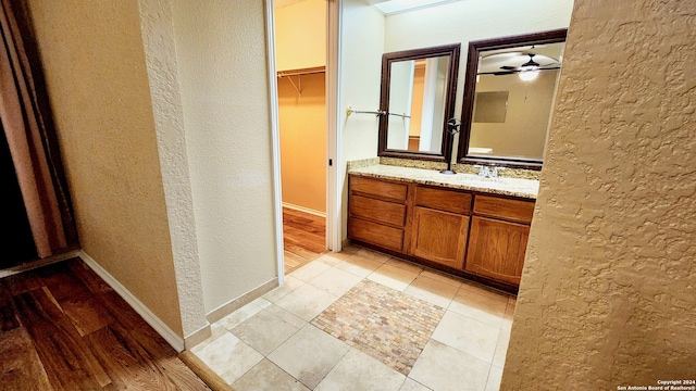 bathroom featuring vanity, ceiling fan, and wood-type flooring