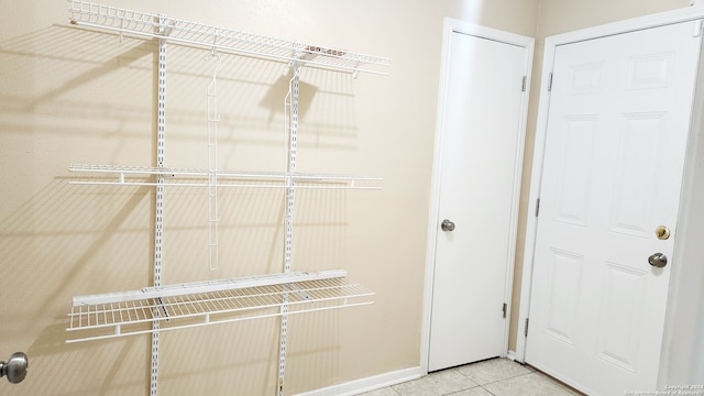 walk in closet with tile patterned flooring