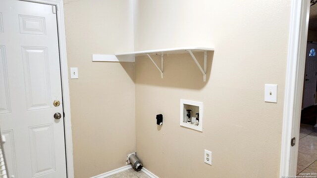 washroom featuring laundry area, washer hookup, light tile patterned flooring, and baseboards