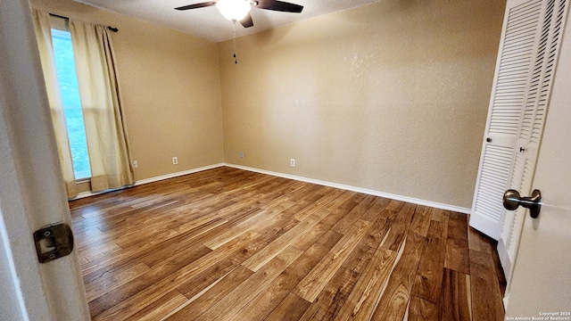 empty room featuring hardwood / wood-style flooring and ceiling fan