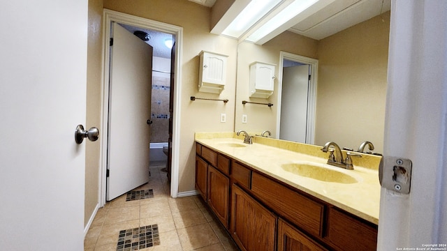 bathroom with tile patterned flooring, vanity, and toilet