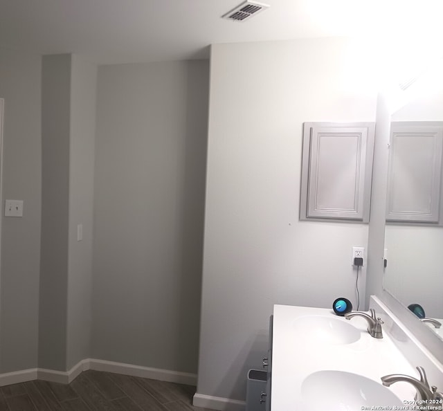 bathroom featuring vanity and hardwood / wood-style floors