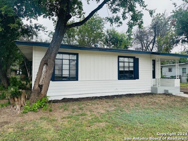 view of side of home featuring a lawn