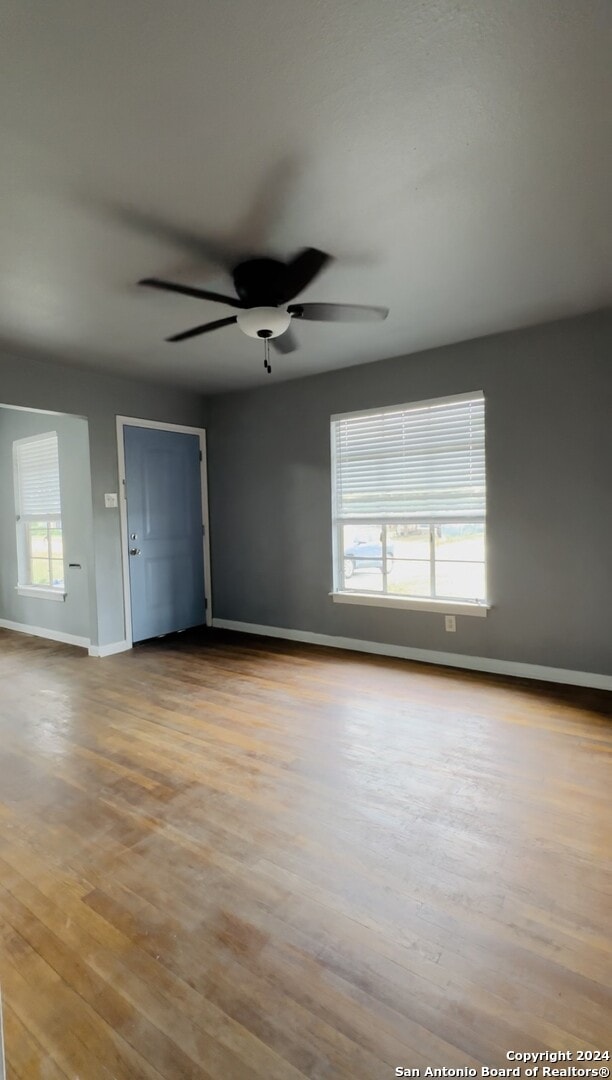 spare room featuring ceiling fan and light hardwood / wood-style flooring