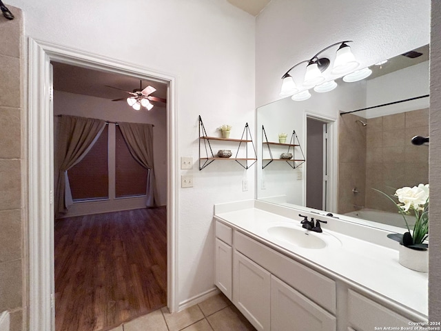 bathroom featuring vanity, ceiling fan, tile patterned floors, and tiled shower / bath