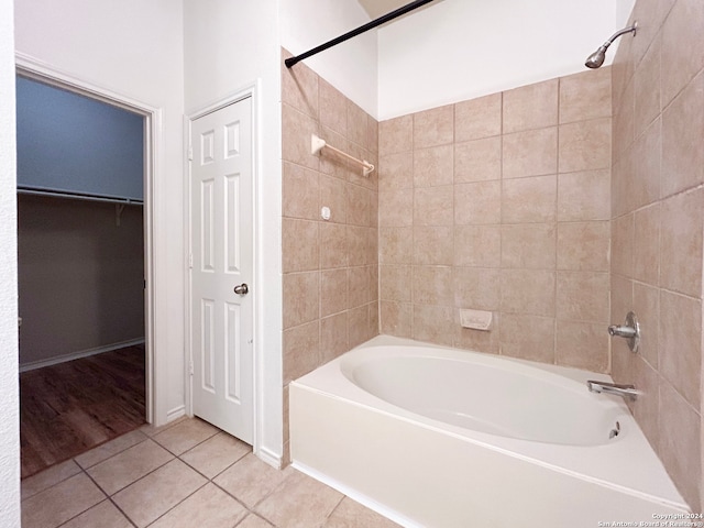 bathroom featuring hardwood / wood-style flooring and tiled shower / bath combo