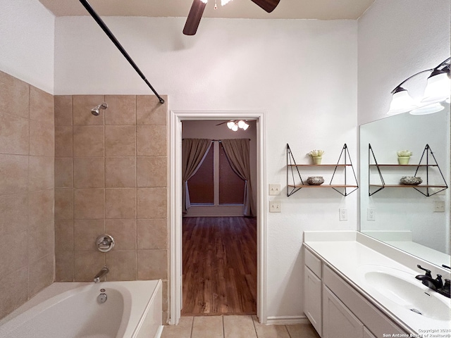 bathroom featuring ceiling fan, vanity, tiled shower / bath, and tile patterned flooring