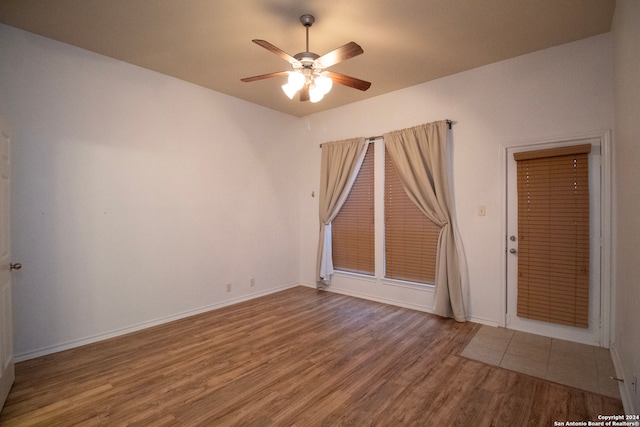 spare room featuring hardwood / wood-style floors and ceiling fan