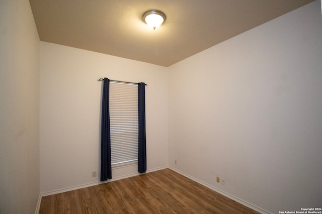 spare room featuring wood-type flooring