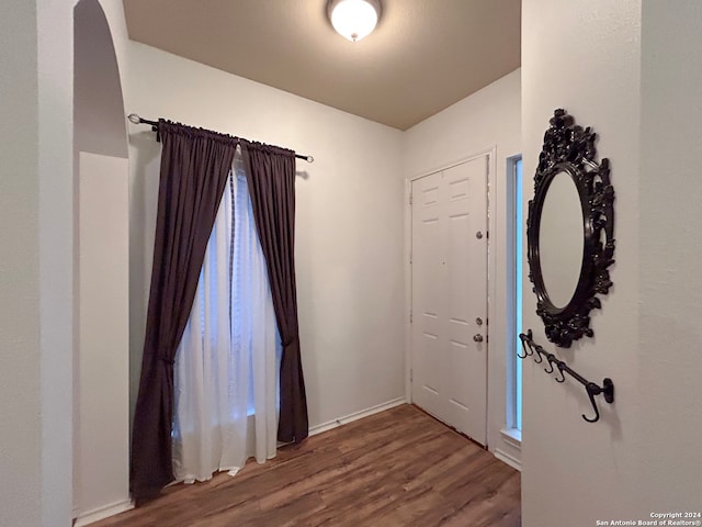 entryway with dark wood-type flooring