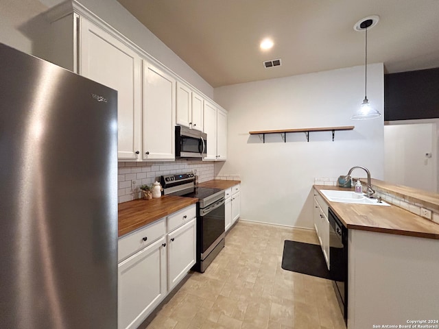 kitchen featuring backsplash, light tile patterned floors, stainless steel appliances, sink, and butcher block counters