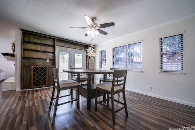 dining space with a textured ceiling, a wealth of natural light, ceiling fan, and dark hardwood / wood-style floors