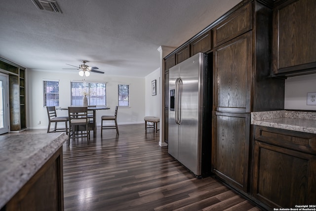 kitchen with stainless steel fridge, dark brown cabinets, dark wood-type flooring, ceiling fan, and a textured ceiling