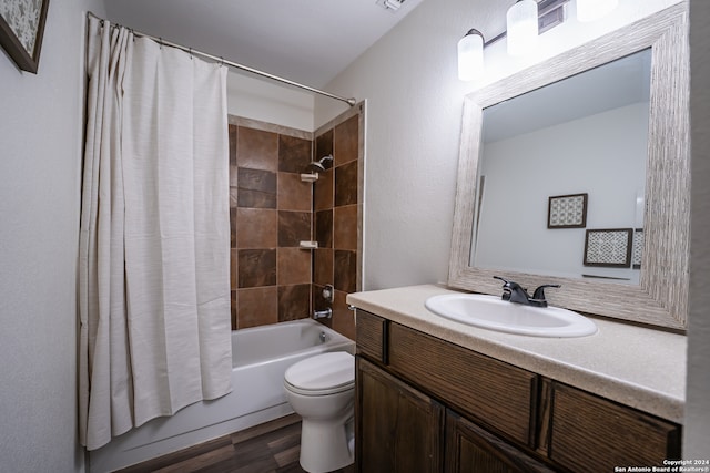 full bathroom featuring shower / bath combination with curtain, toilet, hardwood / wood-style flooring, and vanity