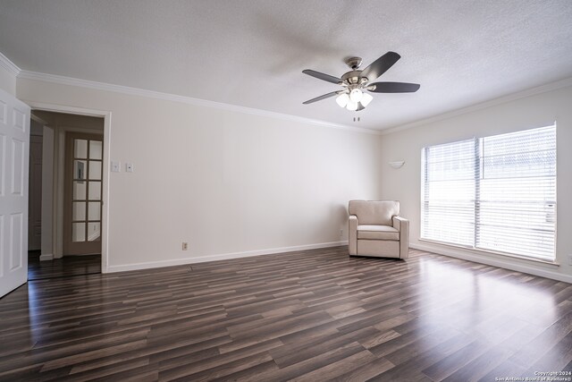 unfurnished room featuring ceiling fan, dark hardwood / wood-style flooring, and crown molding