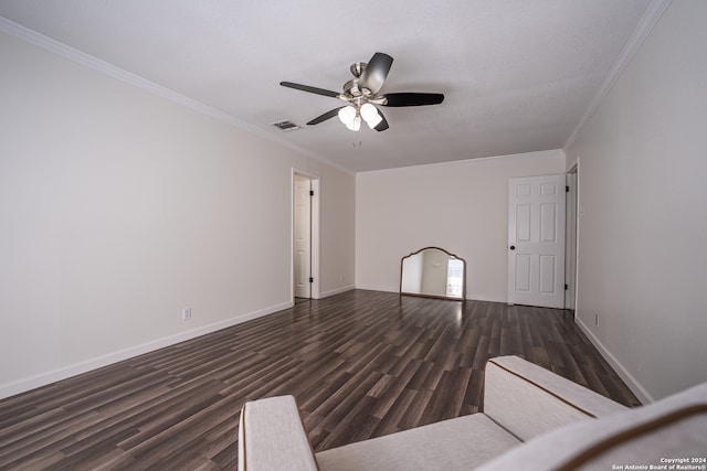 interior space featuring ceiling fan, ornamental molding, and dark hardwood / wood-style flooring