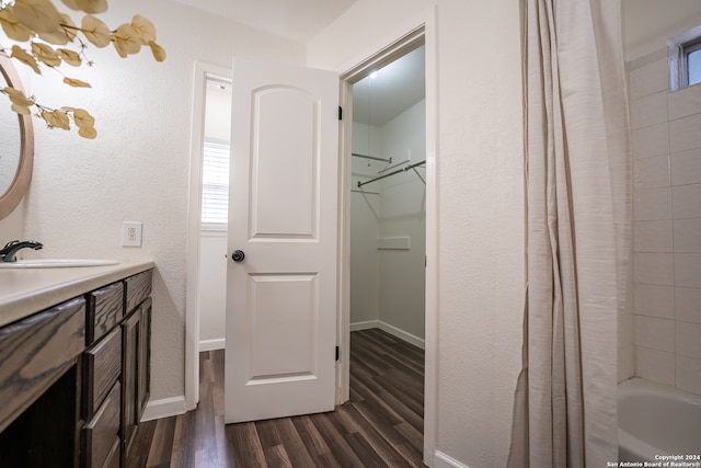 bathroom featuring vanity, wood-type flooring, and shower / bathtub combination with curtain