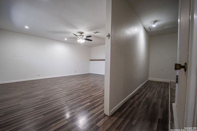 unfurnished room featuring dark wood-type flooring and ceiling fan