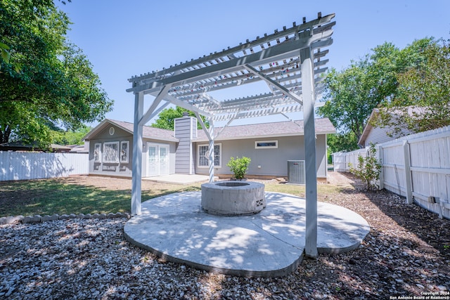 exterior space with a patio area, an outdoor fire pit, and a pergola