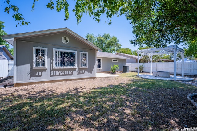 rear view of property with a pergola and a patio