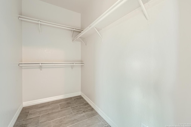 spacious closet with wood finish floors