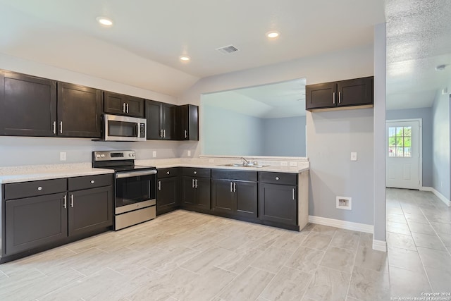 kitchen with stainless steel appliances, light countertops, visible vents, and a sink