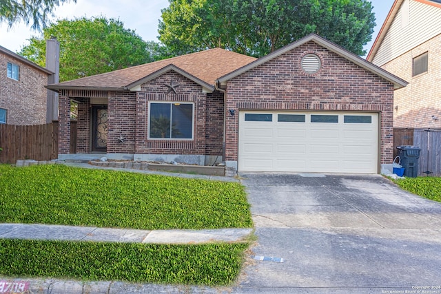 view of front of house with a garage and a front lawn