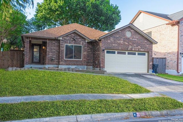 view of front facade with a front yard and a garage